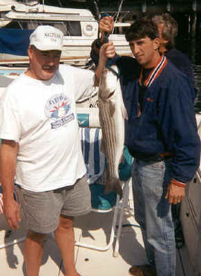 Two happy fishermen with a catch from Many Waters